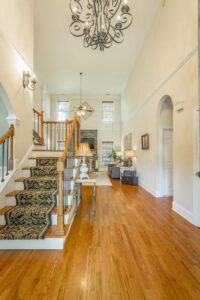 A large open foyer with wood floors and white walls.