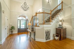 A large foyer with wooden floors and stairs.