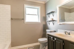 A bathroom with a toilet, sink and tub.