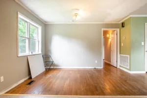 A room with hard wood floors and white walls.