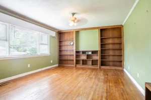 A room with wooden floors and green walls.