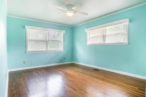 A room with blue walls and wooden floors