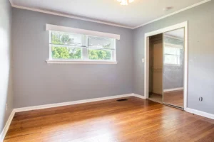 A room with wood floors and a window.