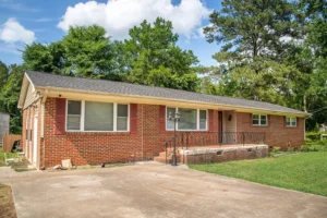 A brick house with trees in the background.