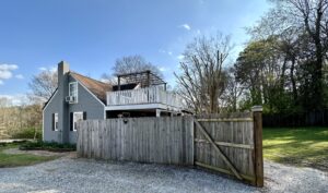 A wooden fence with a house in the background.