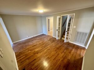 A room with wooden floors and white walls.