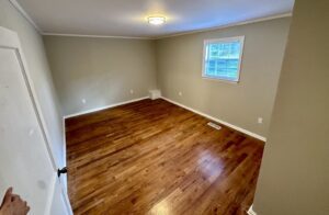 A room with wood floors and a window.