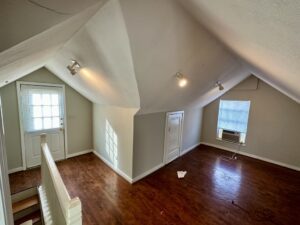 A room with wooden floors and white walls.