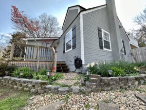 A house with rocks and plants in the yard