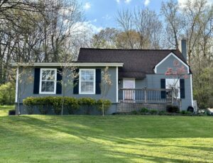 A house with a lot of green grass in front