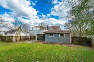 A house with a large yard and a blue sky