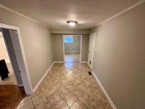 A hallway with tile floors and walls.