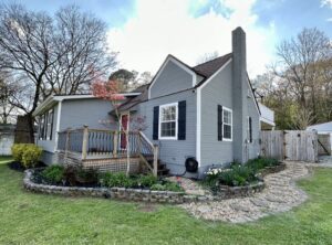 A house with a porch and steps leading to the front door.