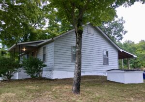 A house with a tree in front of it