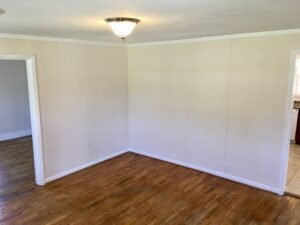 A room with wood floors and white walls.