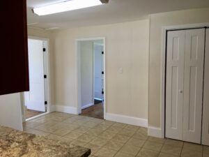 A room with two doors and a tile floor.