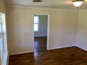 A room with wood floors and white walls.