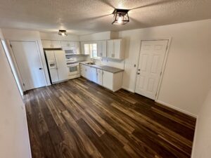 a kitchen room with ceiling lights