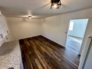 a kitchen space with wooden floor