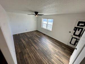 an empty bedroom with a window