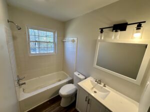 a bathroom with a mirror and shower tub