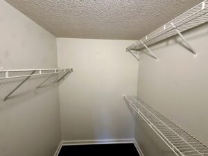 Empty closet with white wire shelves.