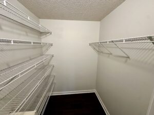 Empty walk-in closet with shelves.