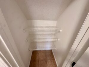 White wire shelves in a closet.