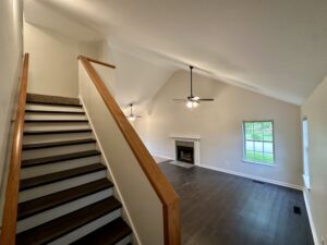 Staircase leading to open living room.