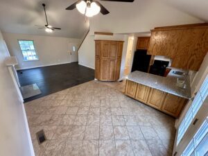 Kitchen with granite countertops and tile floors.