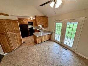 Kitchen with tiled floor and french doors.