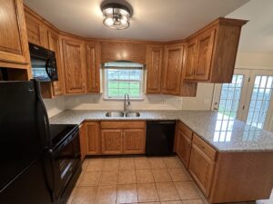 Kitchen with wood cabinets and granite counters.