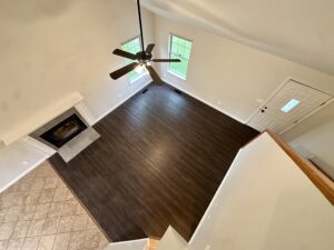 Ceiling fan in a living room with fireplace.