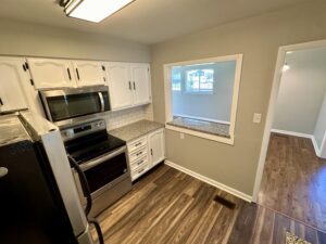 Modern kitchen with stainless steel appliances.