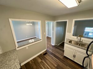 Kitchen with granite countertops and white cabinets.