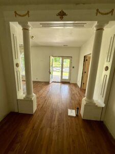 Wood floor with pillars and doorway.