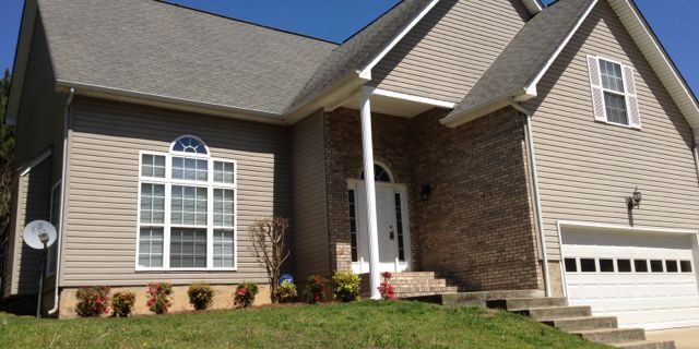 Brick and siding suburban house with garage