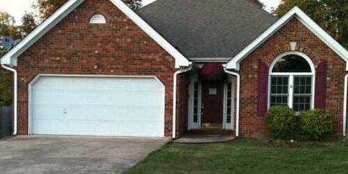 Arched-window brick home with two-car garage