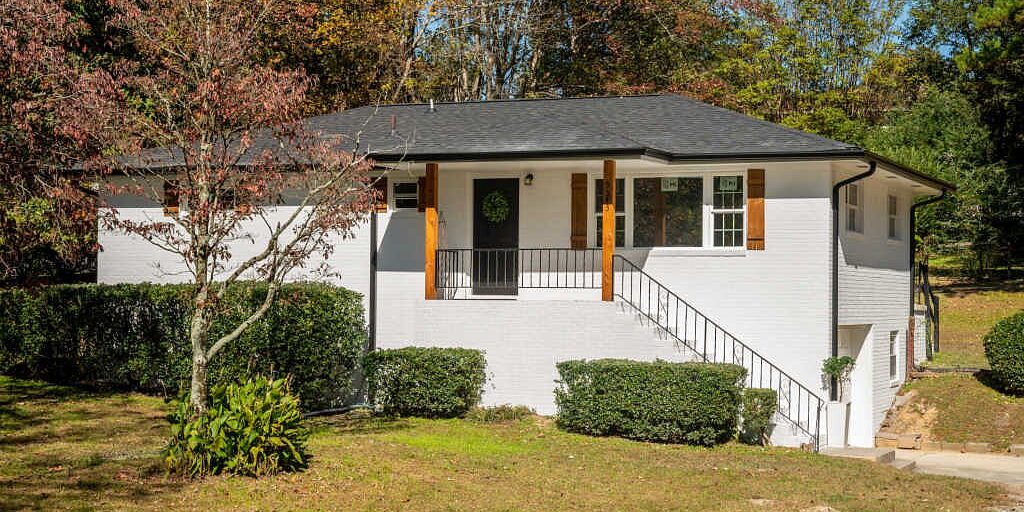 White brick raised ranch with front staircase