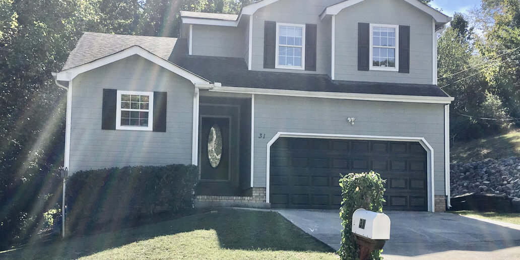 Two-story gray house with attached garage
