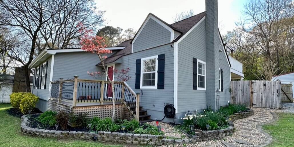 A house with a porch and steps leading to the front door.