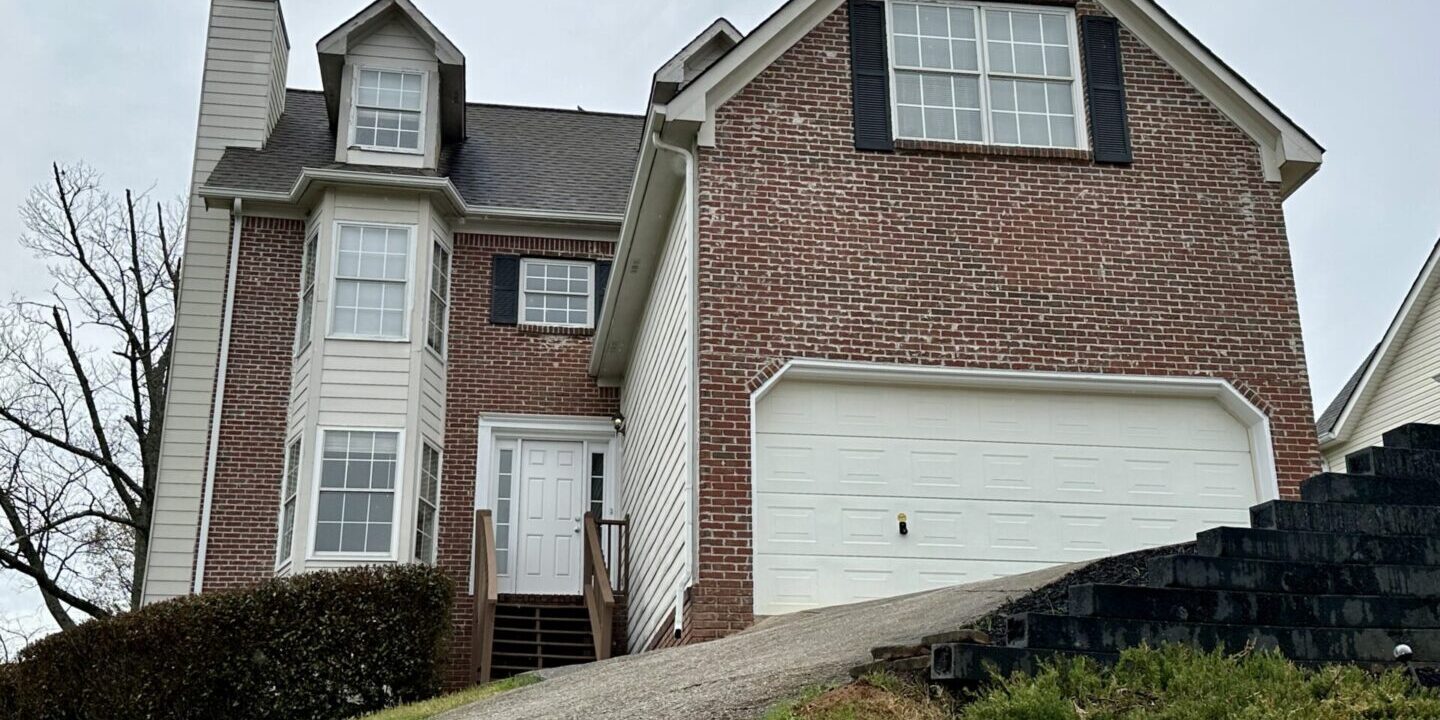 Brick two-story house with steep driveway