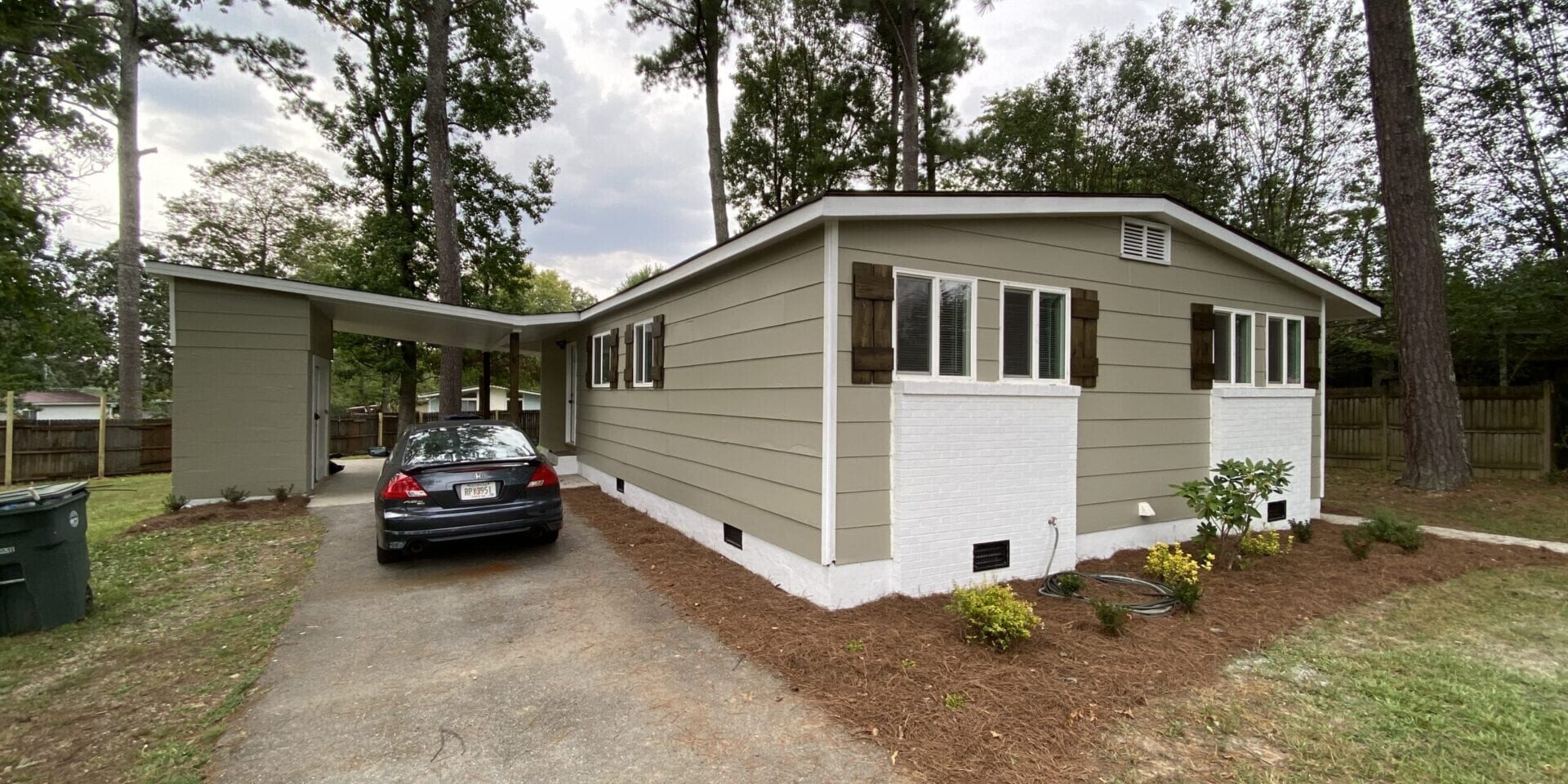 Beige single-story manufactured home with carport