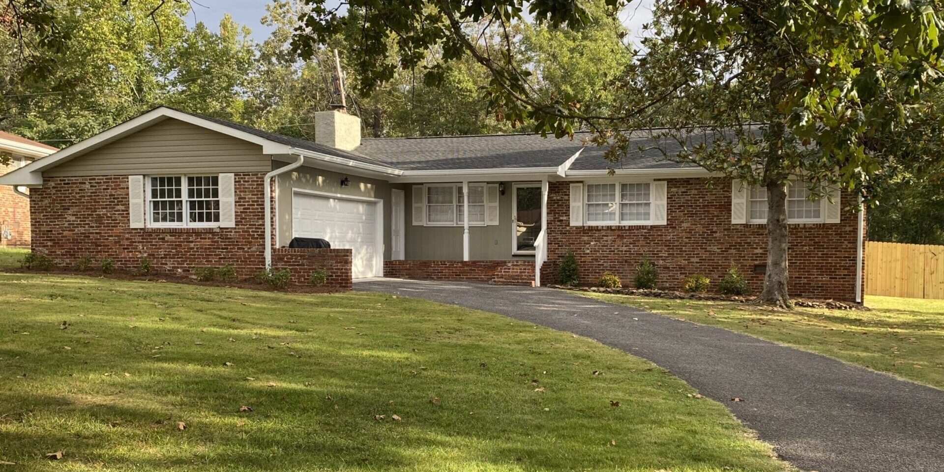 Single-story brick ranch home with driveway